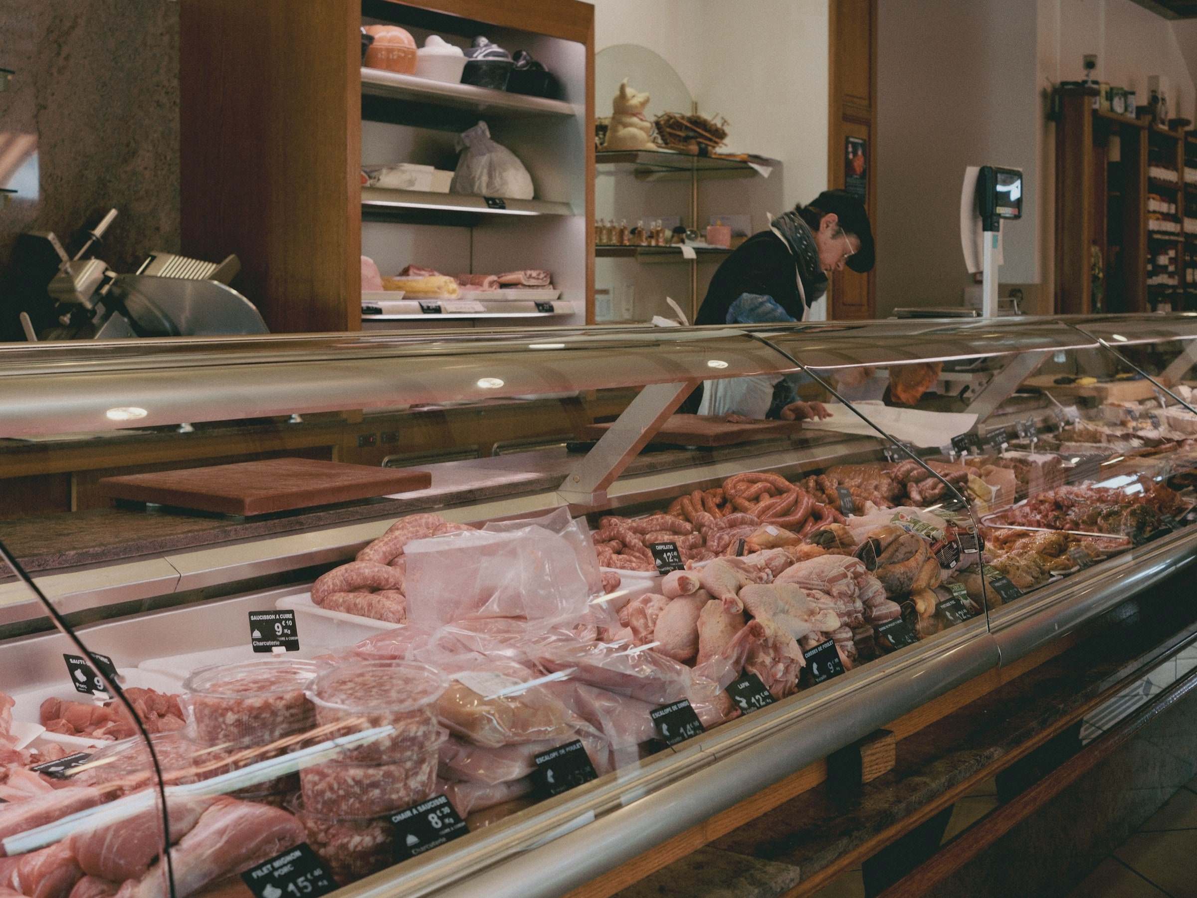 A butcher at work behind the counter